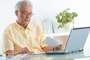 Elderly person reviewing finances, representing Social Security payments