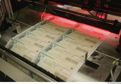 Photo of government checks being printed, illustrating implementation lag