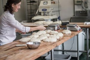 Bakery owner preparing dough