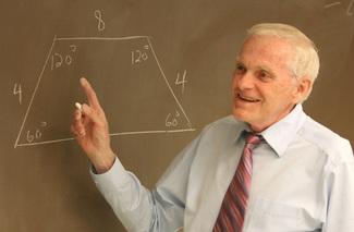 A teacher explaining geometry, representing human capital