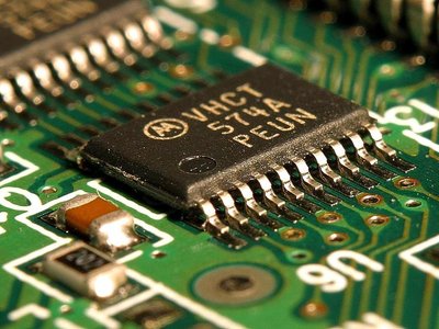 A computer chip, representing technology embodied in physical capital