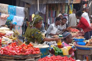 Traditional open-air market with sellers and buyers