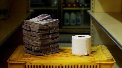 Stack of currency next to a roll of toilet paper during hyperinflation