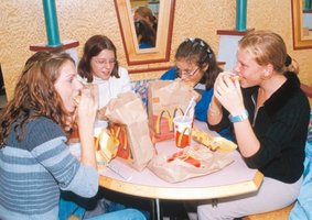 People eating at a fast food restaurant, illustrating demand for inferior goods
