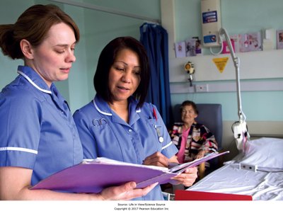 Nurse and medical assistant reviewing a patient's chart