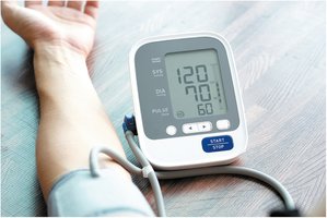 Digital blood pressure monitor showing normal reading