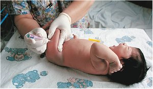 Intramuscular injection in infant's thigh