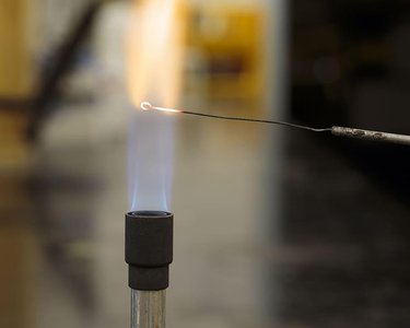 Sterilization of inoculating loop in flame
