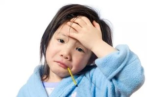Child with headache, representing microbiota disruption
