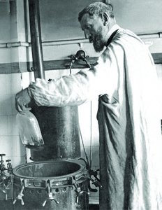 Louis Pasteur conducting swan-necked flask experiment