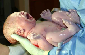 Newborn being colonized by microbiota