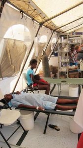 Cholera treatment center with patients receiving oral rehydration