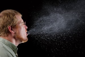 Person sneezing, illustrating respiratory transmission