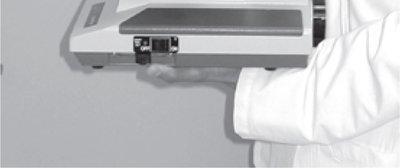 Carrying the microscope with both hands