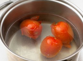 Blanching tomatoes in boiling water