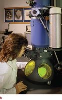 Scientist using a transmission electron microscope