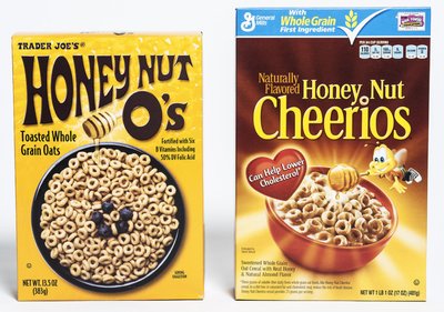 Two boxes of breakfast cereal: Honey Nut O's and Honey Nut Cheerios