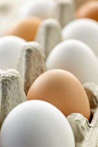Brown and white eggs in a carton