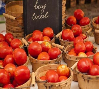 Farmers market with baskets of tomatoes