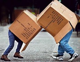 Children boxing with cardboard boxes, representing competition