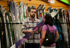 Sales representative assisting a customer in a ski shop