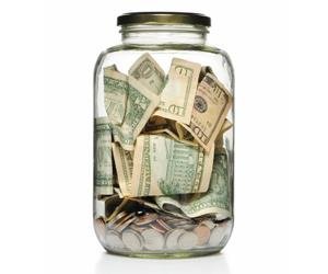 A jar filled with cash, representing tax collection