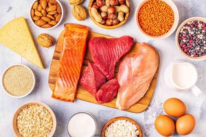 Variety of protein-rich foods including meat, fish, eggs, dairy, nuts, and legumes