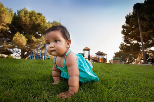 Infant crawling outdoors