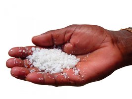 Hand holding salt, representing sodium