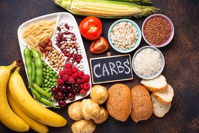 Variety of carbohydrate-rich foods including fruits, grains, and legumes