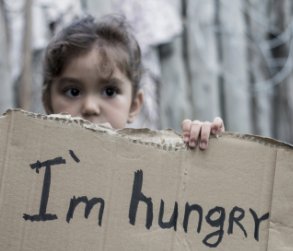 Child holding a sign that says 'I'm hungry'