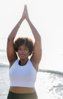 Person practicing yoga on the beach