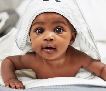 Newborn baby under a towel
