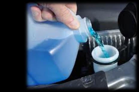 Pouring antifreeze into a car