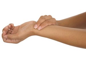 Person palpating wrist to measure heart rate