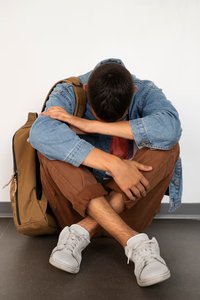 Adolescent hugging self