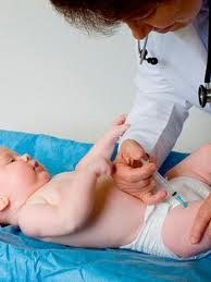 Nurse administering vaccine to infant