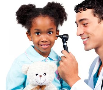 Child receiving hearing check from healthcare provider