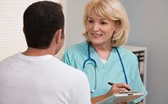 Nurse interviewing patient with clipboard