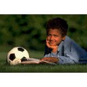 Child reading with soccer ball