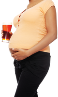Pregnant woman holding a glass of alcohol