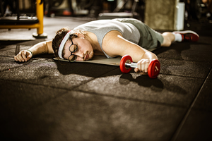 Person experiencing burnout after exercise, illustrating the importance of balance