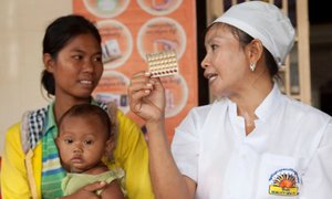 Health worker showing contraceptive pills