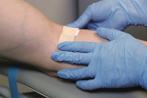 Applying bandage after venipuncture