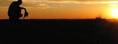 Person in solitude at sunset, symbolizing reflection and transcendence