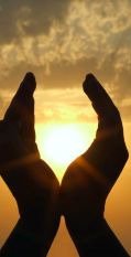 Hands raised to the sun, symbolizing spirituality and hope