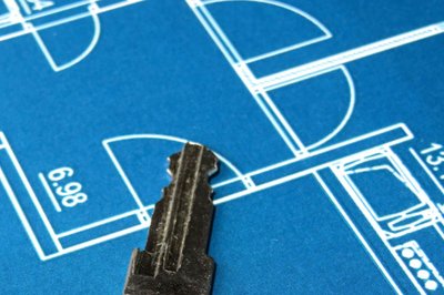 Blueprint with a key, symbolizing planning and transition