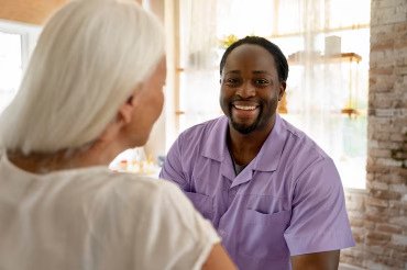 Nurse interacting with a patient, illustrating the caregiving role