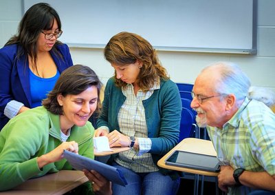Group of adults in a classroom setting, representing collaborative learning