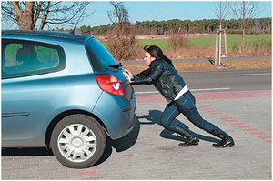 Woman pushing a car